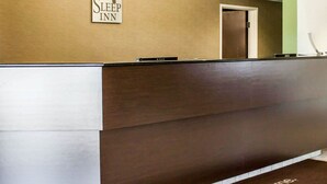 A reception desk with a sign reading "Sleep Inn" and a welcome mat. - Sleep Inn Nampa near Idaho Center (Nampa)