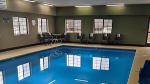 An indoor swimming pool with clear water, surrounded by lounge chairs and a poolside area. - Sleep Inn Nampa near Idaho Center (Nampa)