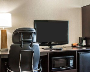 A hotel room with a black leather chair, a flat-screen TV, a microwave, and a coffee maker on the counter. - Sleep Inn Nampa near Idaho Center (Nampa)