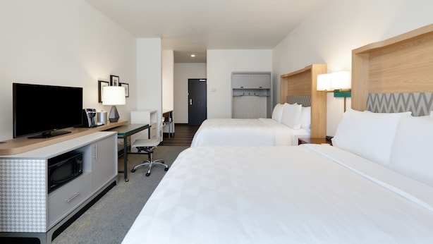 A hotel room with a TV, desk, two beds, and a kitchenette. - Holiday Inn Twin Falls by IHG (Twin Falls)