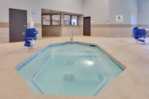 Una piscina con borde azul, un reloj y un cartel de elevador para la piscina.