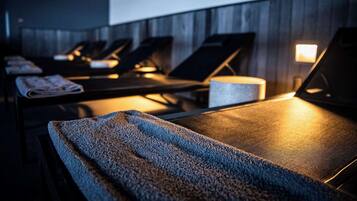 Experience soothing massages in our serene spa rooms, each equipped with a massage table.