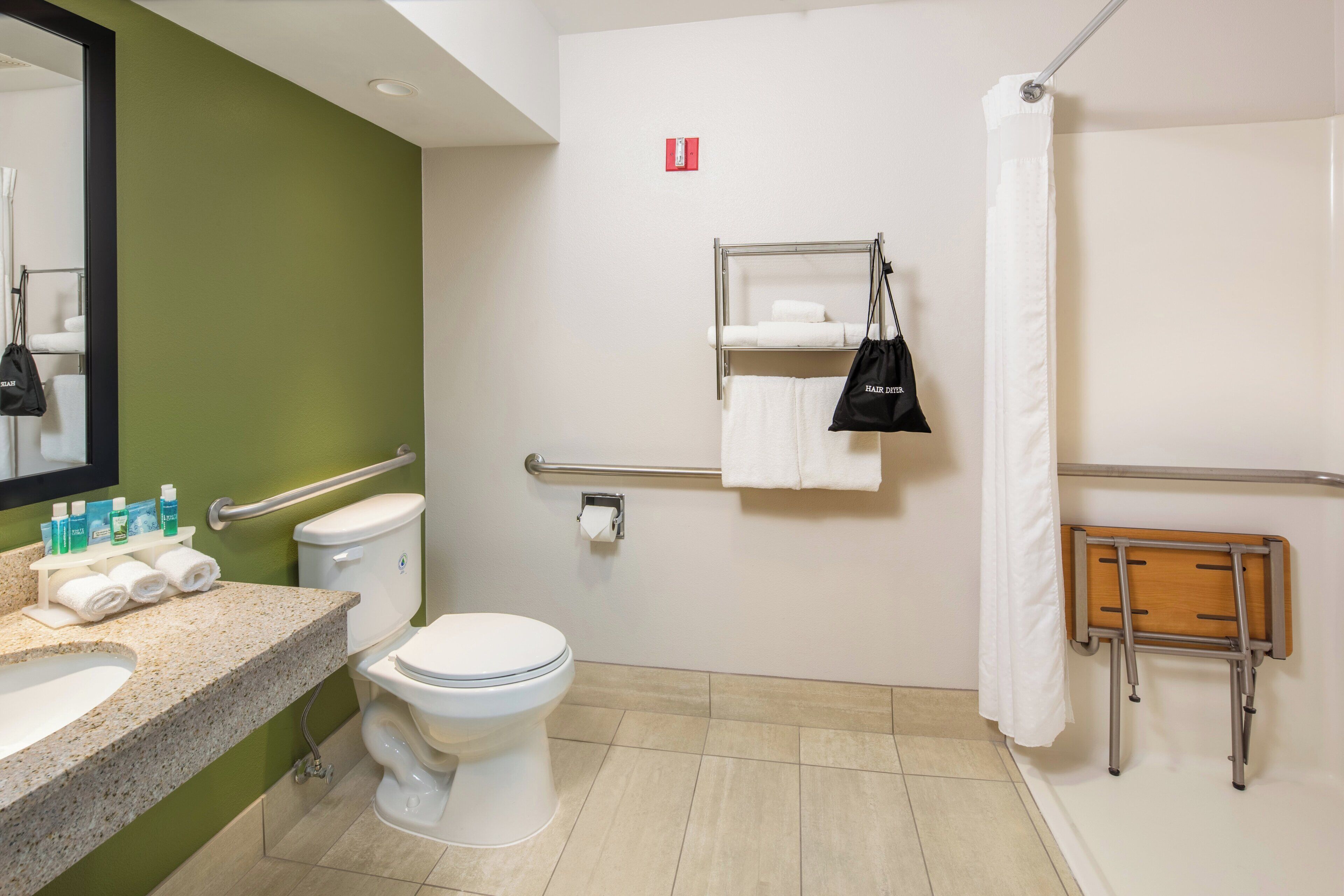 A bathroom with a toilet, sink, and shower area.
