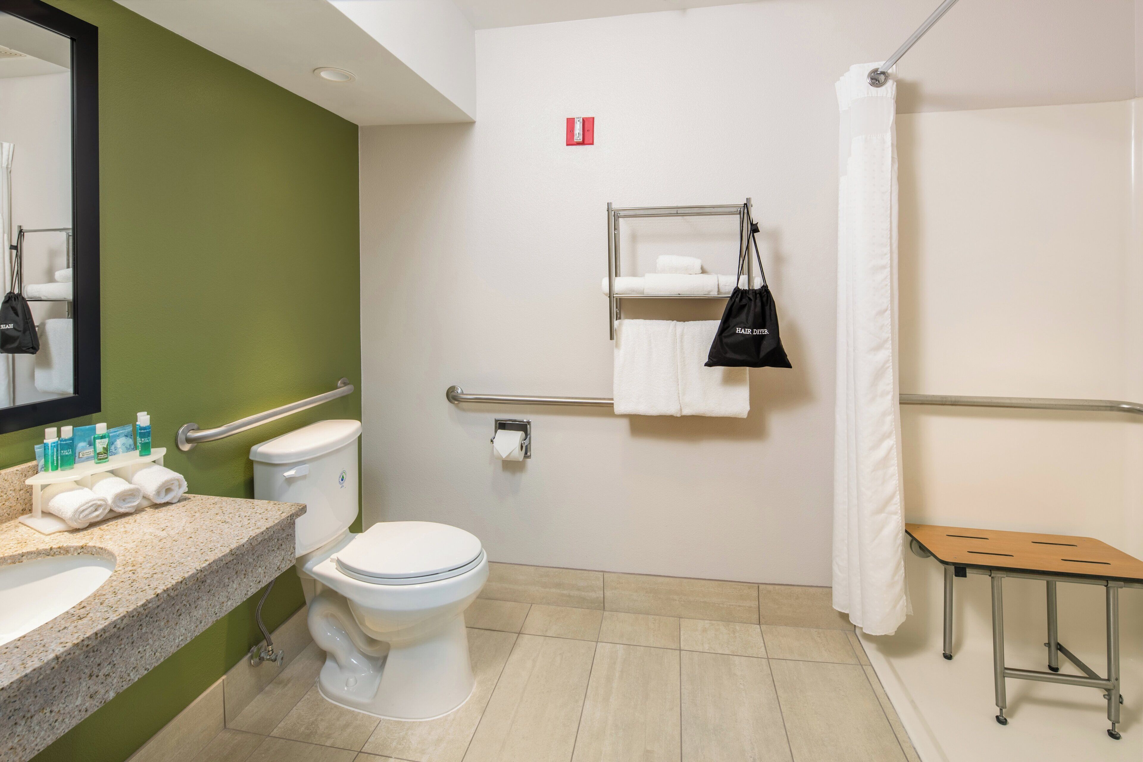 A bathroom with a toilet, sink, and shower area.