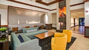 A lobby with seating areas, a fireplace, and a view of the hallway. - Hyatt Place Baltimore/BWI Airport (Linthicum Heights)