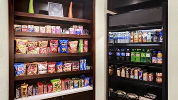 A pantry with shelves stocked with snacks, beverages, and condiments.