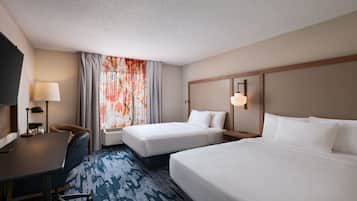Premium bedding, desk, laptop workspace, blackout drapes
