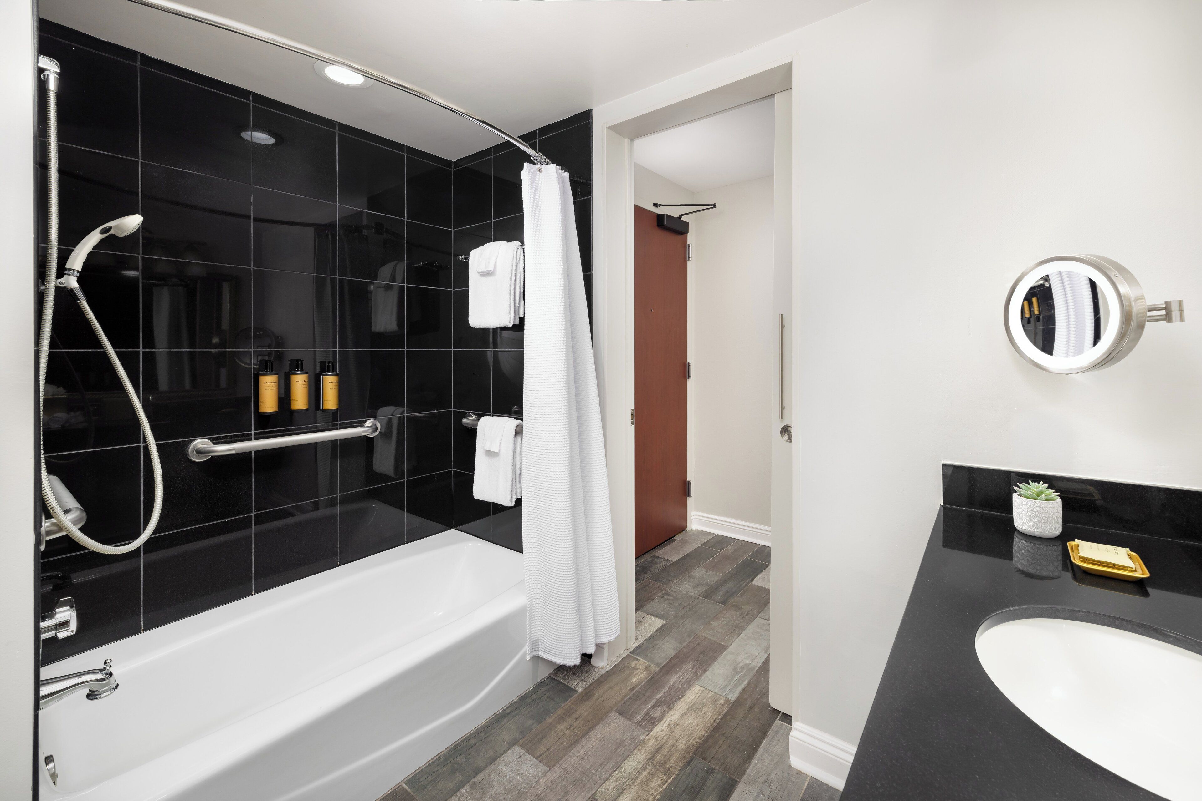 deluxe room, 1 king bed, mobility accessible | bathroom | designer toiletries, hair dryer, bathrobes, towels