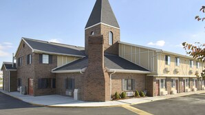 A multi-story hotel with a prominent brick tower and a flat-roofed annex.