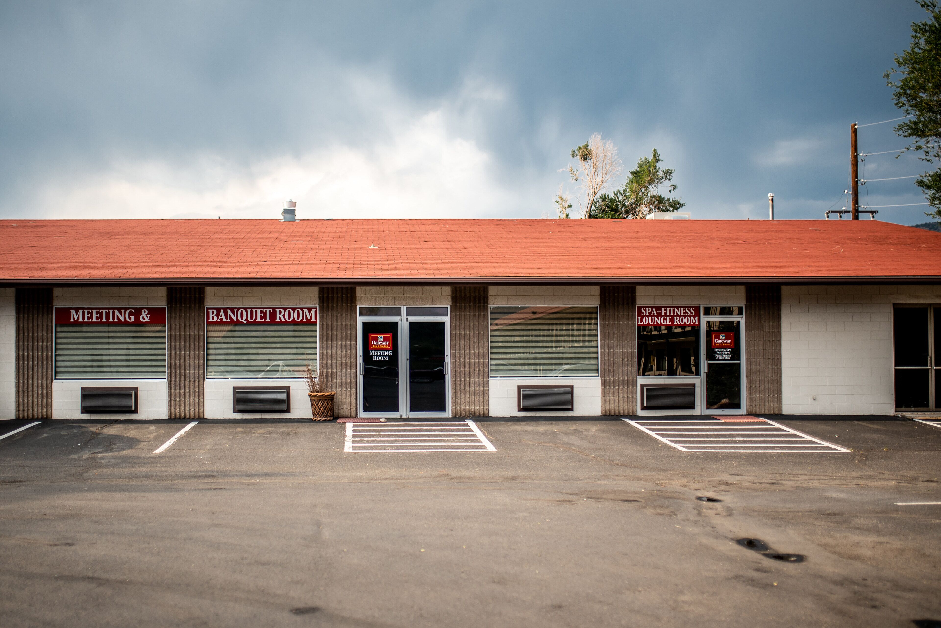 A building with three doors labeled "Meeting & Banquet Room," "Spa Fitness Lounge Room," and a closed door.