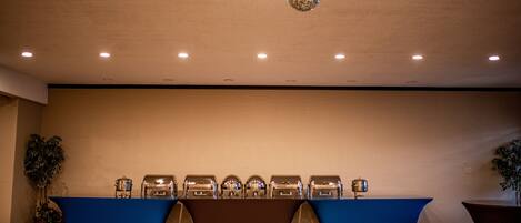 A conference room with a long table, ceiling lights, and a disco ball.
