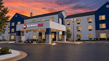 A Best Western Plus hotel with a modern design, featuring a prominent entrance and a landscaped area in front.