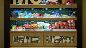 A snack display with various packaged snacks and a 'Treats' sign above.