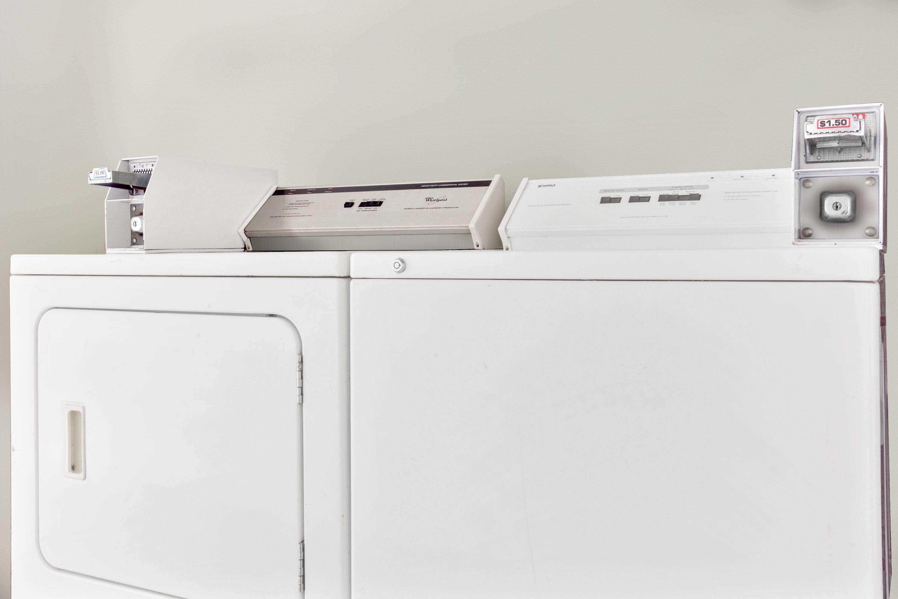 A white washing machine with a control panel and a price tag.