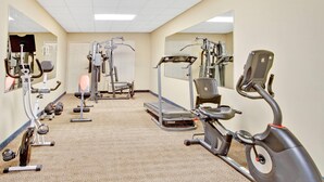 A gym with cardio machines, weight machines, and free weights. - Days Inn & Suites by Wyndham Stockbridge South Atlanta (Stockbridge)