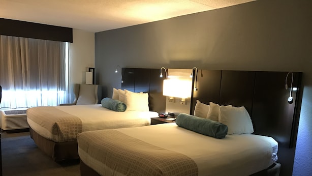 A hotel room with two beds, a nightstand, a lamp, and a window with curtains. - Best Western Plus Roswell / Alpharetta (Roswell)