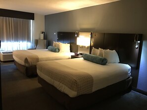 A hotel room with two beds, a nightstand, a lamp, and a window with curtains. - Best Western Plus Roswell / Alpharetta (Roswell)