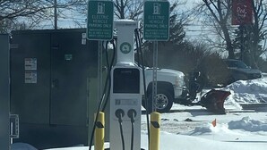 A snow-covered parking area with electric vehicle charging stations. - Red Roof Inn Rochester – Airport (Rochester)