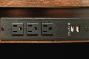A power strip with three standard electrical outlets and a USB port, labeled "DC 5V 2.1A MAX".