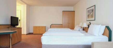 A hotel room with a bed, a desk, a television, a wardrobe, and a painting on the wall.