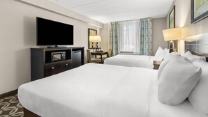 A hotel room with two beds, a TV, a desk with a lamp, and a window with curtains. - Comfort Inn Rehoboth Beach (Rehoboth Beach)