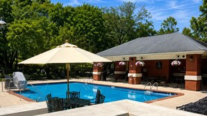 A swimming pool with lounge chairs and a covered seating area. - Homewood Suites by Hilton Wilmington-Brandywine Valley (Wilmington)