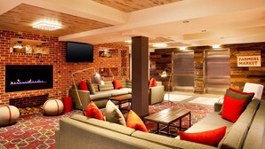 A cozy lounge area with sofas, a fireplace, and a television.