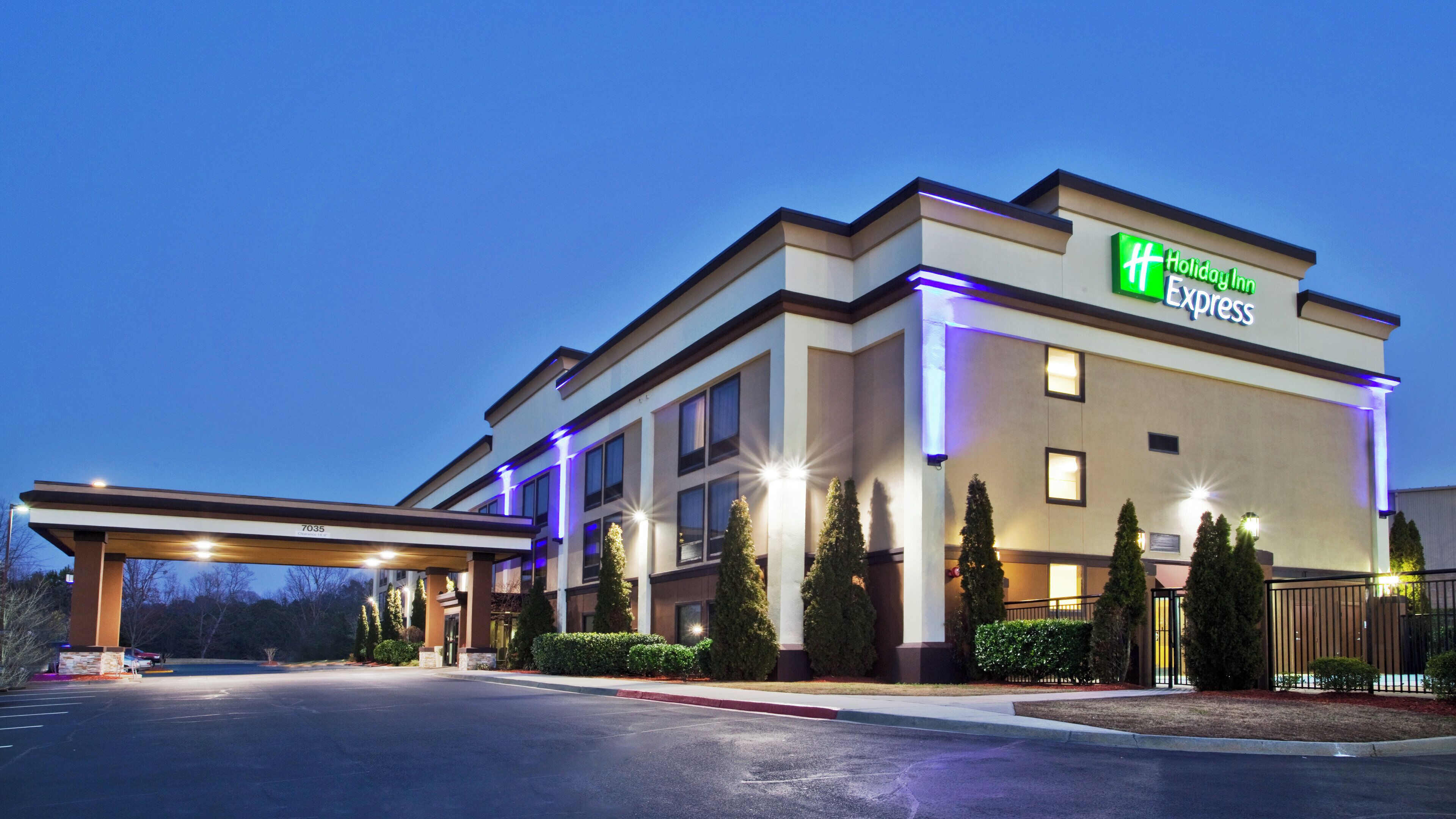 A Holiday Inn Express building with a covered entrance and well-lit exterior.