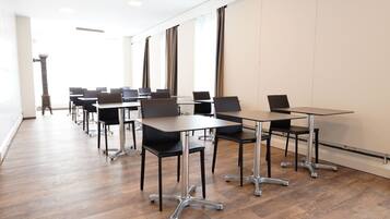 A conference room with a long table, several chairs, and a podium.