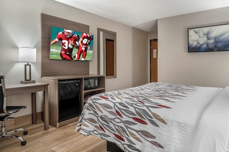 In-room safe, desk, laptop workspace, blackout drapes. Red Roof Inn Queensbury