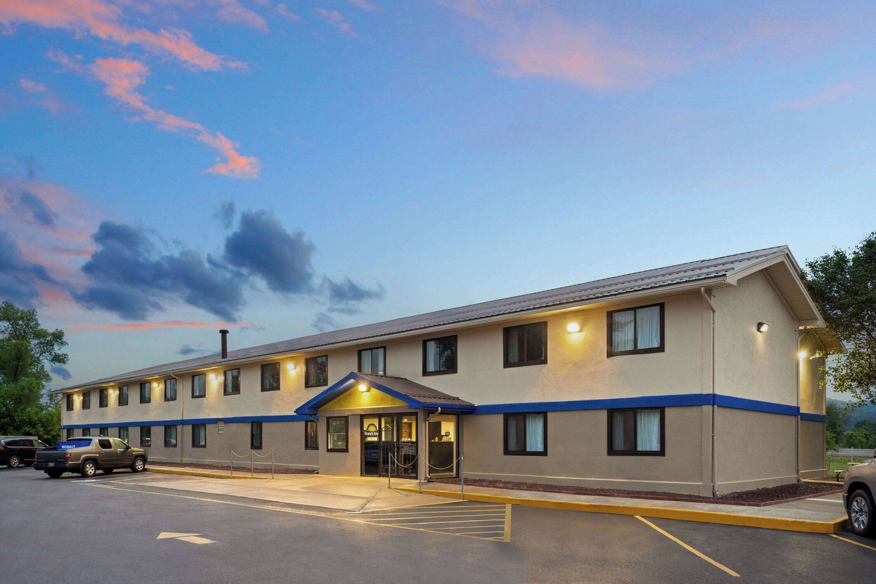 A two-story motel with a flat roof and a blue trim line.