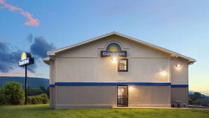Een Days Inn hotel met een eenvoudige, gelijkvloerse structuur, een opvallend Days Inn bord en een goed verlichte ingang.