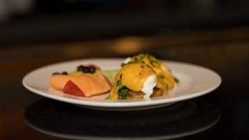 A plate with a dish that includes a poached egg, greens, and a piece of salmon.