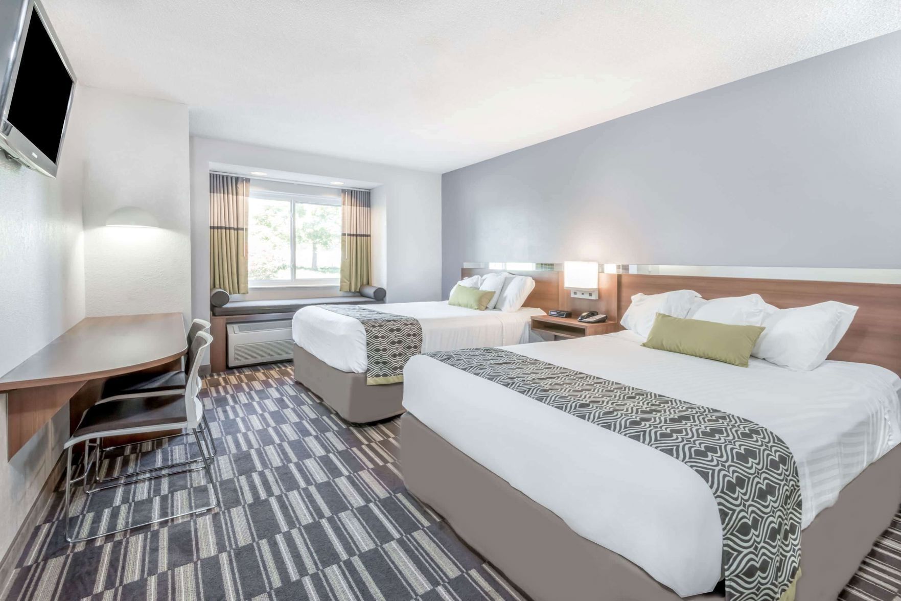 Premium bedding, pillow-top beds, desk, laptop workspace