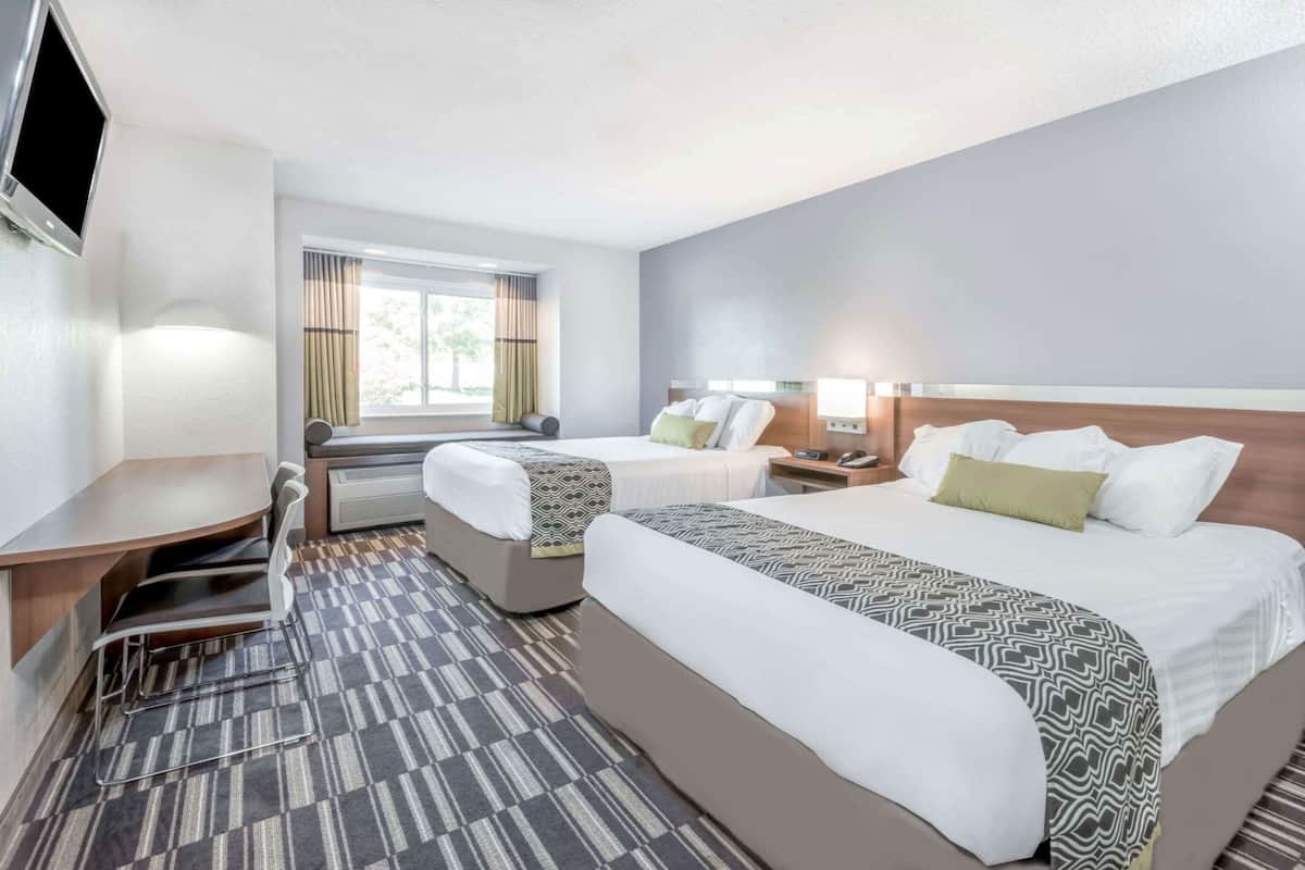 Premium bedding, pillow-top beds, desk, laptop workspace