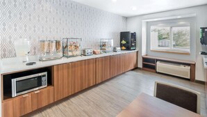 A modern kitchen with a microwave, toaster, and various food containers. - Microtel Inn by Wyndham Victor/Rochester (Victor)