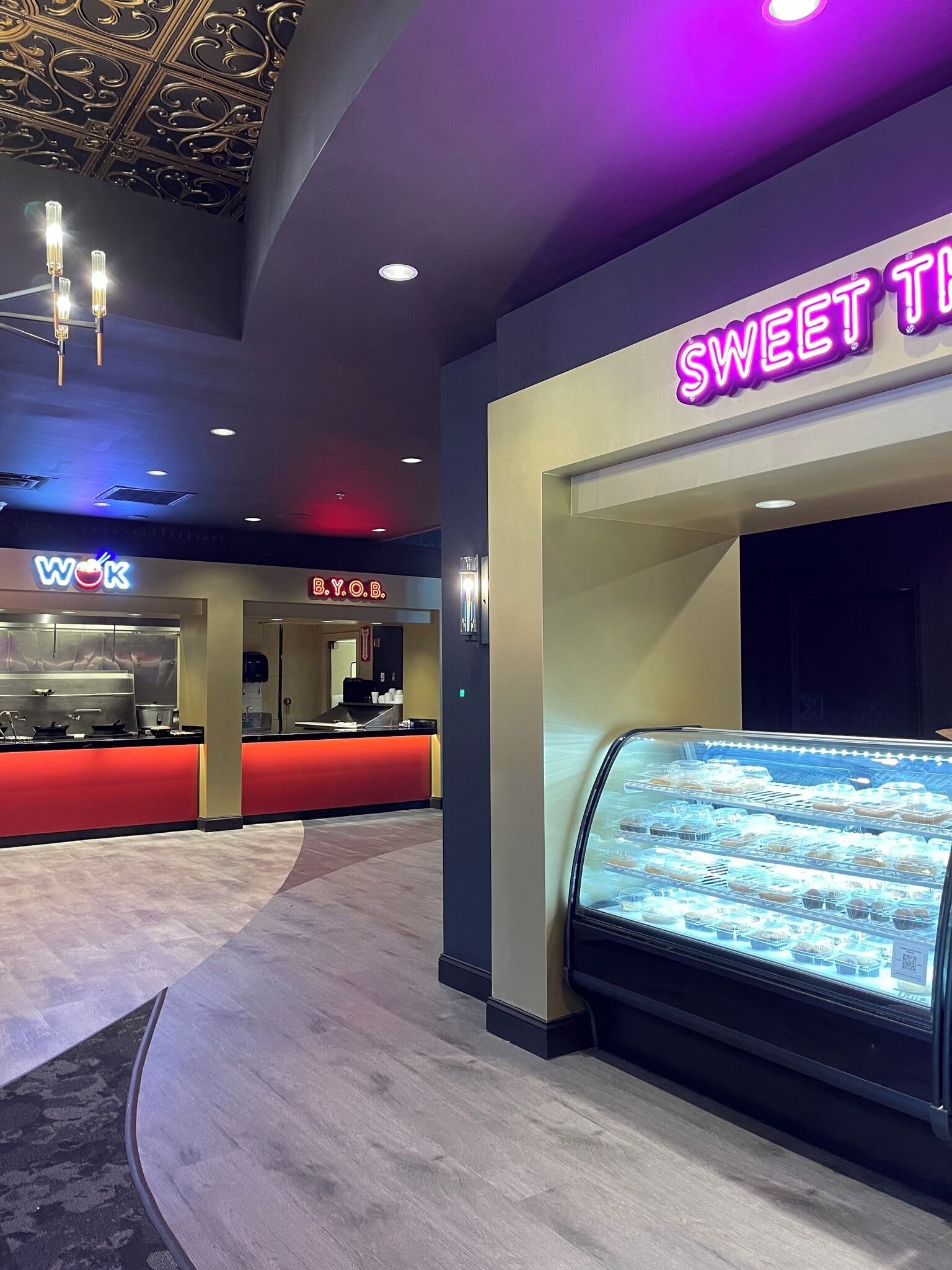 A modern interior with a bakery display and a counter area labeled "WOK".