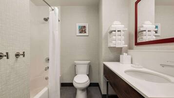 A modern bathroom with a bathtub, toilet, and sink.