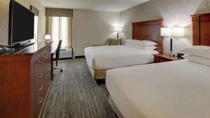A hotel room with two beds, a desk with a television, and a chair. - Drury Inn & Suites Atlanta Marietta (Marietta)