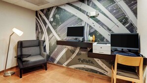 A modern office space with a desk, two monitors, a printer, and a chair. - Drury Inn & Suites Atlanta Marietta (Marietta)