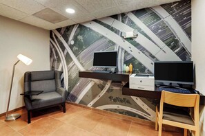 A modern office space with a desk, two monitors, a printer, and a chair. - Drury Inn & Suites Atlanta Marietta (Marietta)