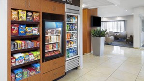 A corner market with shelves of snacks and a refrigerated section. - Fairfield Inn & Suites by Marriott Denver Airport (Denver)