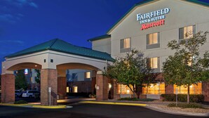 A Fairfield Inn & Suites Marriott hotel with a brick facade, large windows, and a green roof. - Fairfield Inn & Suites by Marriott Denver Airport (Denver)