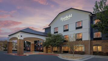 A Fairfield by Marriott hotel with a covered entrance, brick facade, and multiple windows.