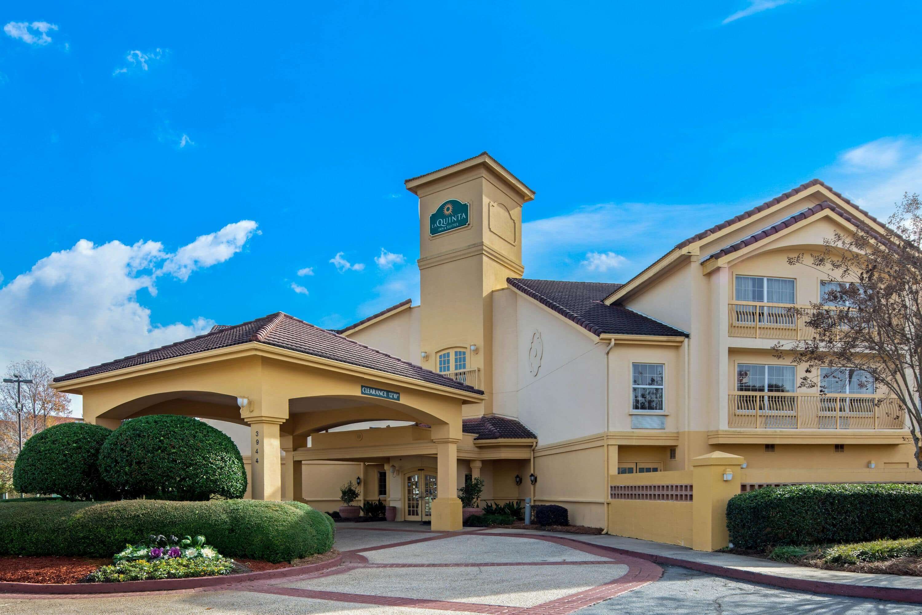 A hotel with a clear entrance, a covered area, and a sign indicating it is a Marriott hotel.
