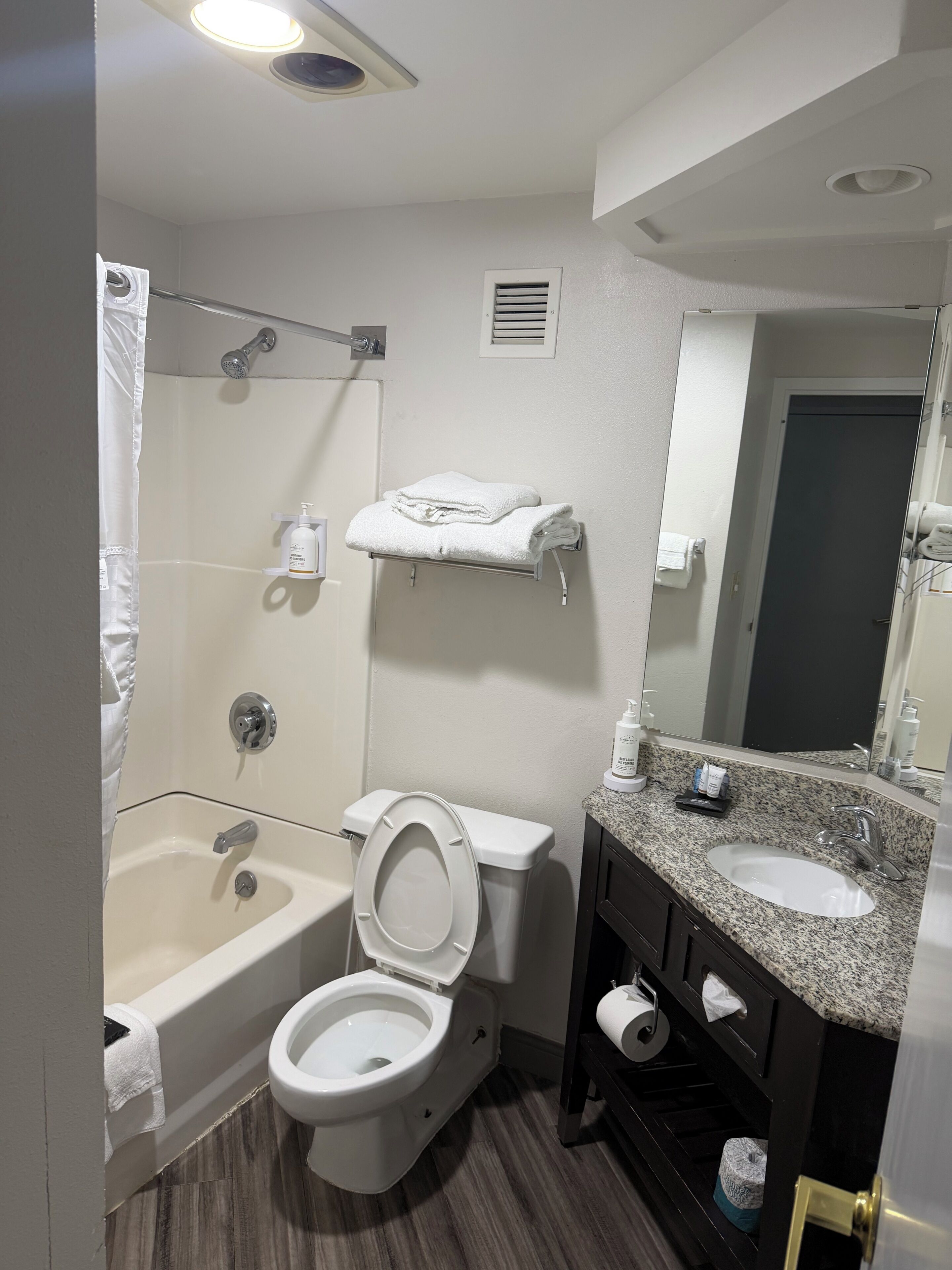 A bathroom with a bathtub, toilet, and sink.