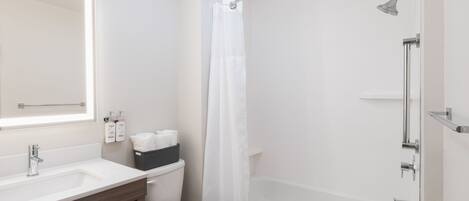 A modern bathroom with a white sink, toilet, and bathtub.