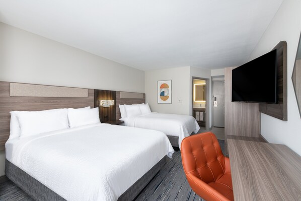 A hotel room with two beds, a TV, a desk, and a chair. - Holiday Inn Express Atlanta West - Theme Park Area by IHG (Lithia Springs)