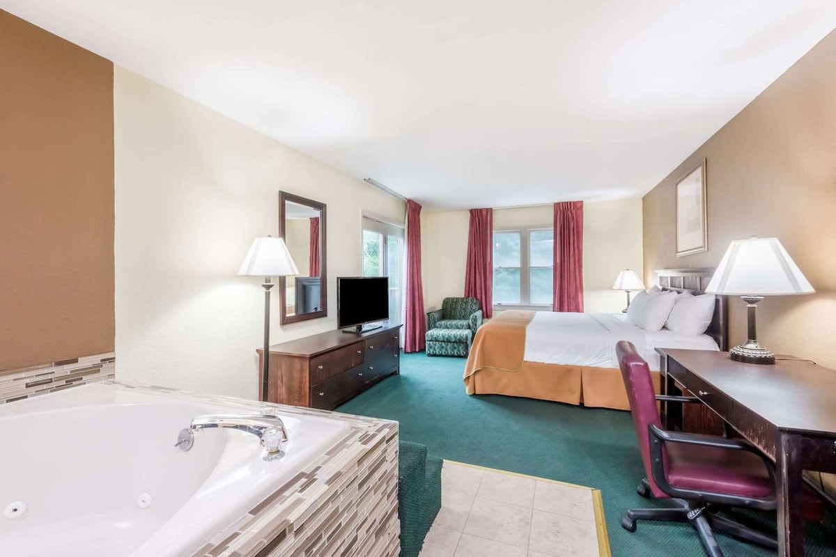 Premium bedding, desk, laptop workspace, blackout drapes