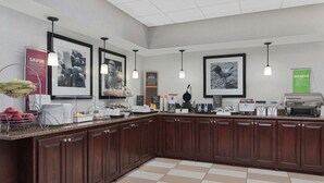 A modern kitchen with a granite countertop, wooden cabinets, and various appliances including a coffee maker and toaster. - Hampton Inn Lagrange near Callaway Gardens (LaGrange)